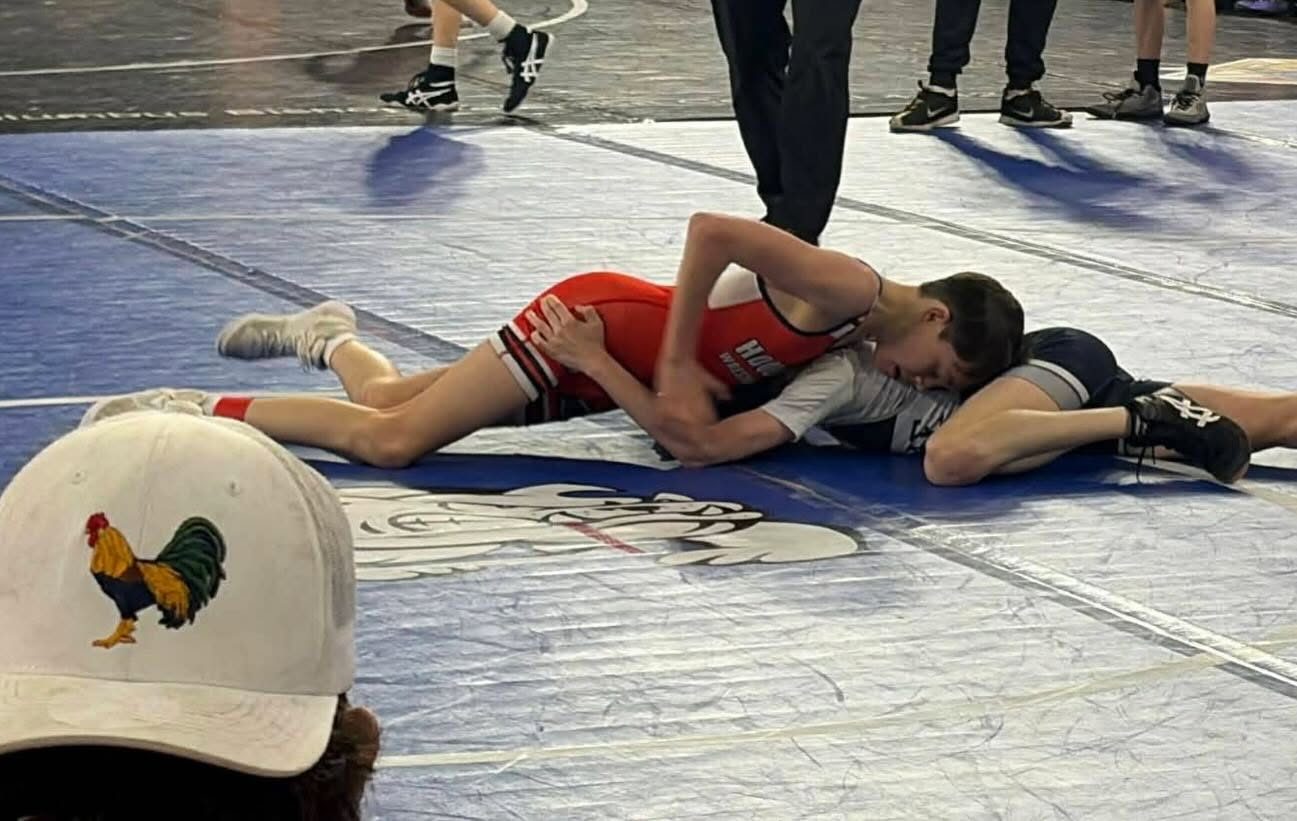 Coach Arnold watching a youth wrestling match